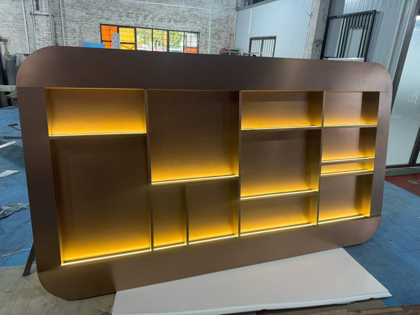 Illuminated architectural feature wall with decorative metal detailing